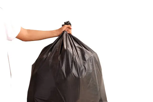 Man hand holding garbage bag isolated on white background