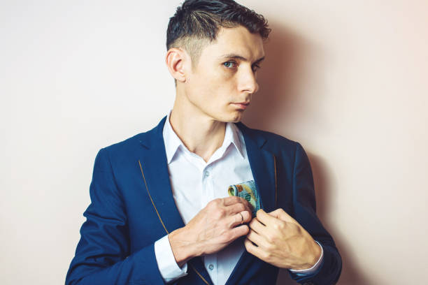 istock man businessman taking notes in pocket as a bribe 815477716