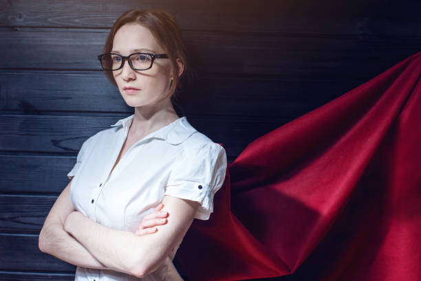 istock Office worker standing in a suit and red cloak 815477840