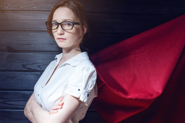 istock Office worker standing in a suit and red cloak 815477858