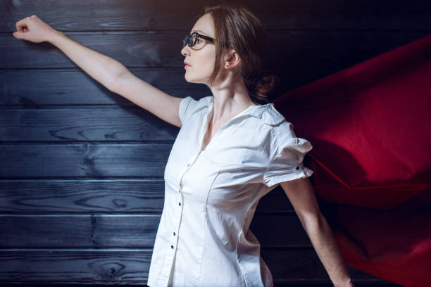 istock Office worker standing in a suit and red cloak 815477862