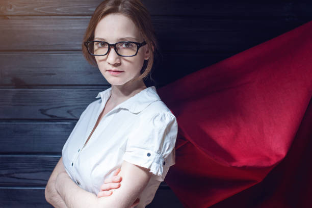 istock Office worker standing in a suit and red cloak 815477884