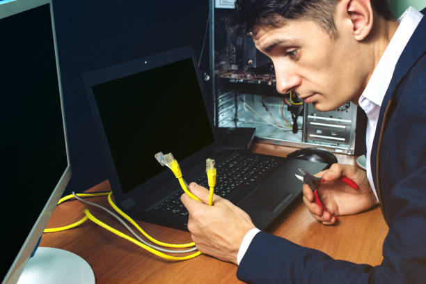 istock man in suit holding network cables concept is the connection 815479734