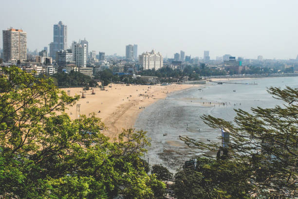 Mumbai Summer City meets beach. Landscape view over Juhu Beach and Mumbai City. Trees in foreground. arabian sea photos stock pictures, royalty-free photos & images