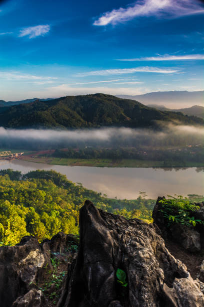 istock hill , fog , and river at sunrise 815480306