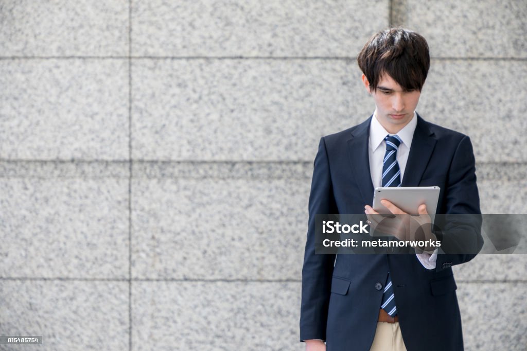 young man using a tablet PC Adult Stock Photo