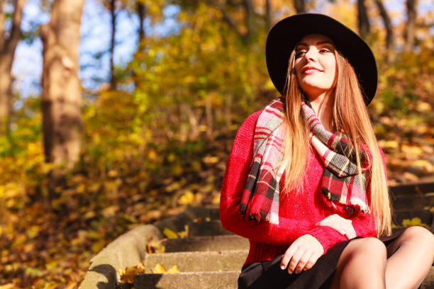 istock Charming woman walking in autumnal park 815500882