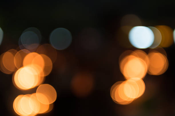 istock Abstract circular bokeh of light in dark background texture 815503398