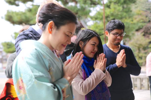 istock People putting their hands together in front of temple 815511860