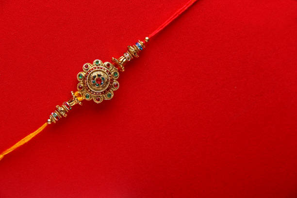 Raakhi on red background Raakhi on red background , Raksha bandhan raakhi raksha bandhan stock pictures, royalty-free photos & images