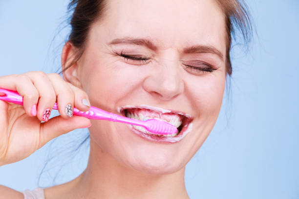 istock Woman brushing cleaning teeth 815533710