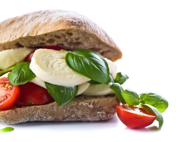 istock Ciabatta with mozzarella, tomato and basil isolated on white 815553824