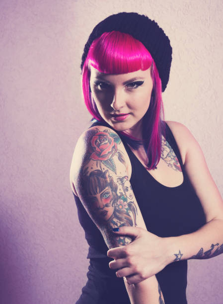 Young woman with pink hair Young punk woman with pink hair. black pin up girl tattoos stock pictures, royalty-free photos & images