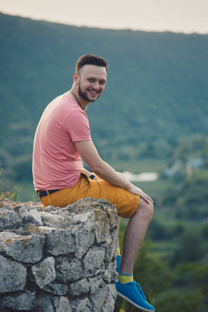 istock Young man smiling and enjoying sunny summer day 815565542