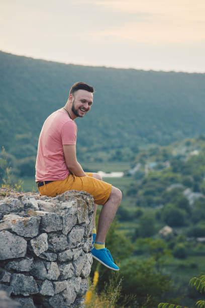 istock Young man smiling and enjoying sunny summer day 815565724
