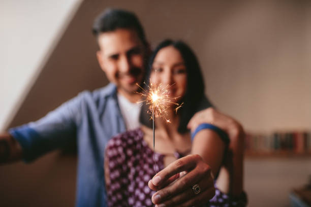 istock Young couple celebrating with sparkler at home 815573164