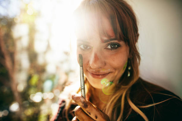 The woman artist paints a picture. / Woman-picture