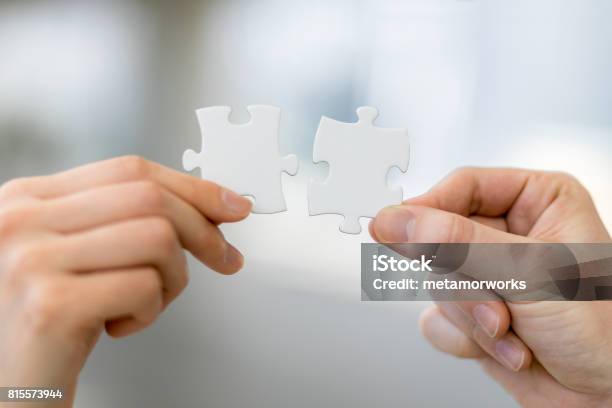 Man And Woman Hand Holding Jigsaw Puzzles Business Matching Concept Stock Photo - Download Image Now