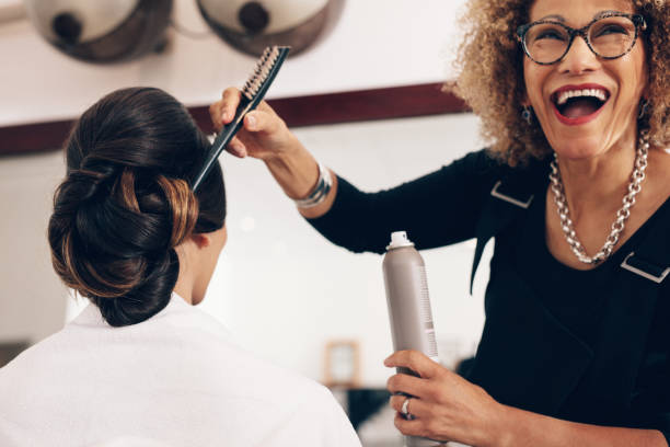 istock Happy looking hair stylist working at salon 815579074