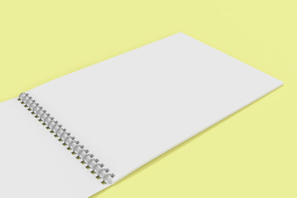 istock Open blank white notebook with metal spiral bound on yellow background 815582024
