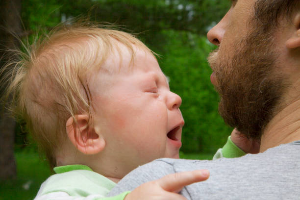 istock Father consoling crying baby boy 815582444