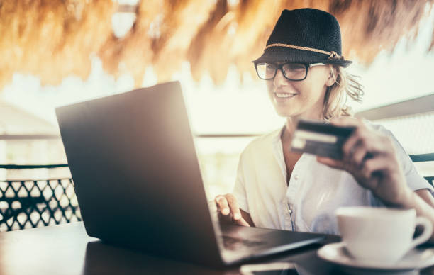istock Pretty woman making online payment on vacation 815594032