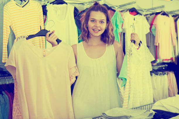 istock Brunette choosing new clothes in shop 815594626