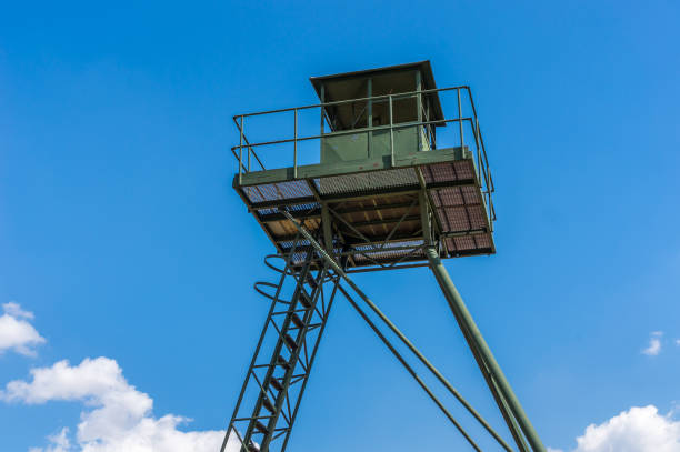 istock Remains of iron curtain with watchtower 815616644