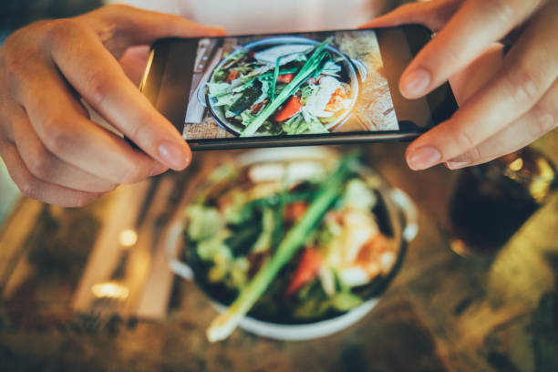 Taking a photo of food Taking a picture of some food with a smart phone. ready to eat photos stock pictures, royalty-free photos & images
