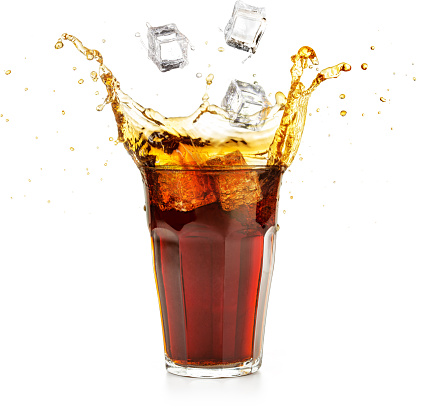 ice cubes falling into a cola drink splashing isolated on white