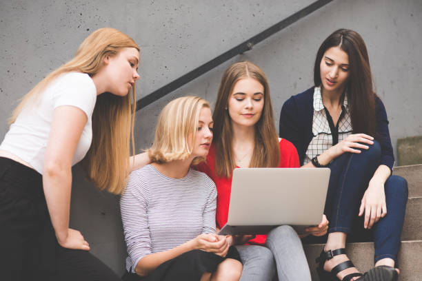 istock Young female friends using  enjoying living in digital age 815630058