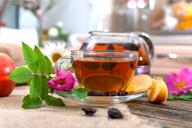 istock Tea with dried dog-rose and apple on a wooden table 815635142