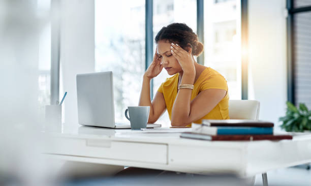 The stress and tension are becoming too much to handle Shot of a young designer looking stressed out while working in an office headache photos stock pictures, royalty-free photos & images
