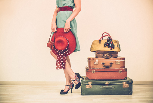 Woman Standing Beside Suitcases