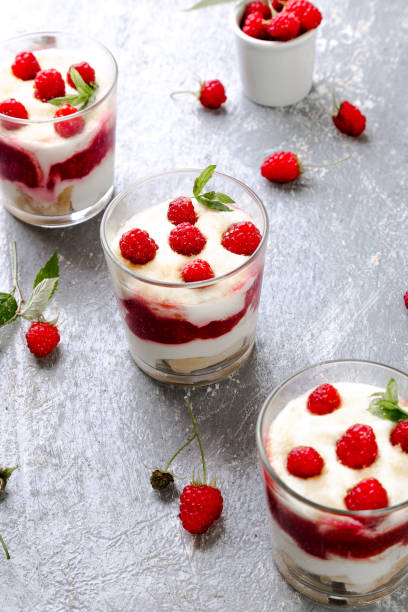 istock Tiramisu with raspberry in glasses on grey background. Three portion. Italian dessert 815646520