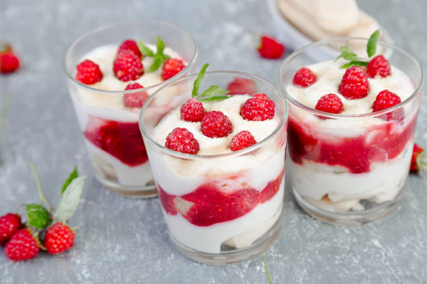 istock Tiramisu with raspberry in glasses on grey background. Three portion. Italian dessert 815646574