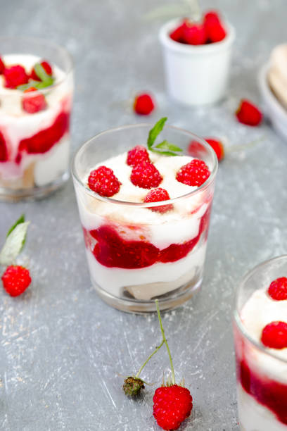 istock Tiramisu with raspberry in glasses on grey background. Three portion. Italian dessert 815646584