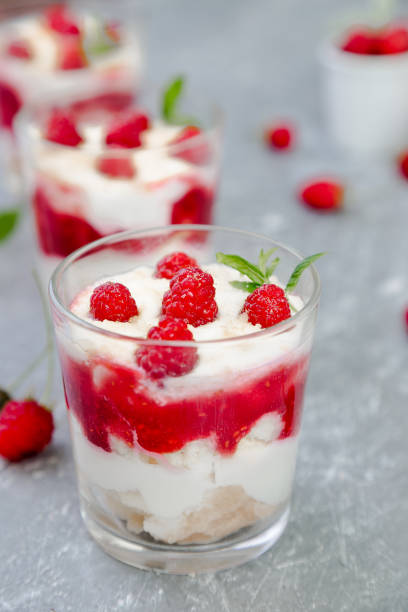 istock Tiramisu with raspberry in glasses on grey background. Three portion. Italian dessert 815646598
