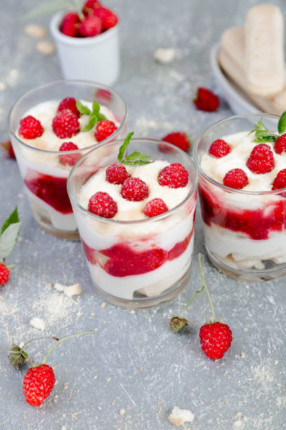 istock Tiramisu with raspberry in glasses on grey background. Three portion. Italian dessert 815646602