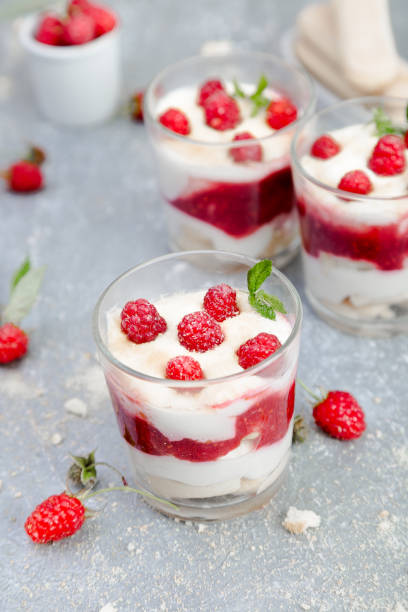 istock Tiramisu with raspberry in glasses on grey background. Three portion. Italian dessert 815646624