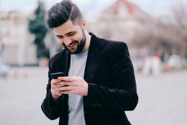 istock Young man with mobile phone in the street 815662534