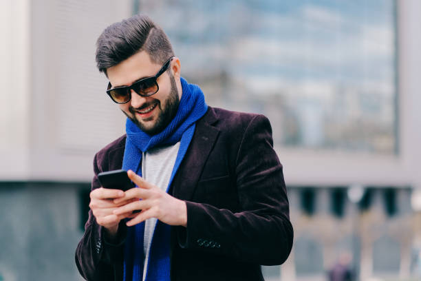 istock Young man with mobile phone in the street 815663076