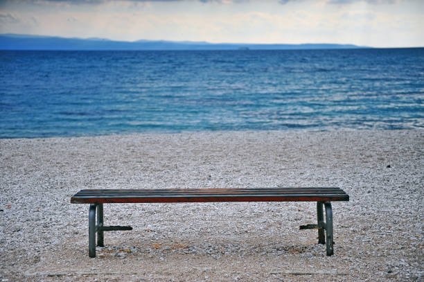 istock Lonely bench at the Mediterranean sea coast 815680928