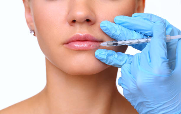 istock Beautiful woman gets an injection in her lips 815683900