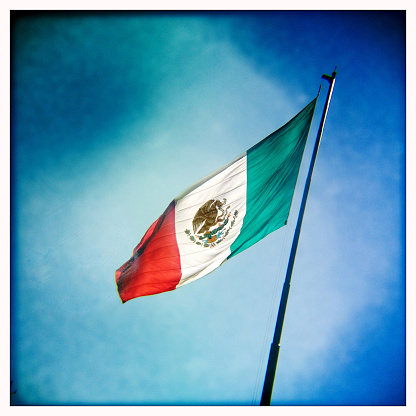 Mexican flag flying in the wind. Shot with an iPhone.