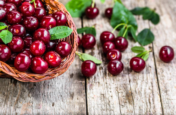 istock Organic cherries, farm fresh fruits on farmer table 815698192