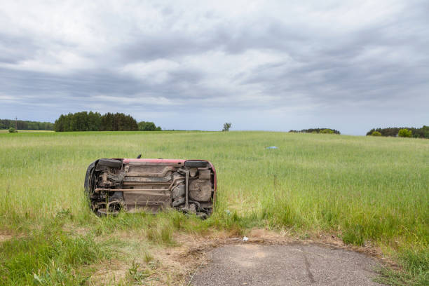 istock Car wreck lying on the side in a grain field 815699178