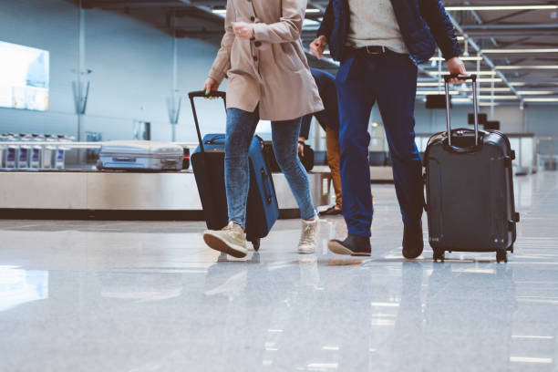 istock Couple at airport terminal with suitcase 815708600