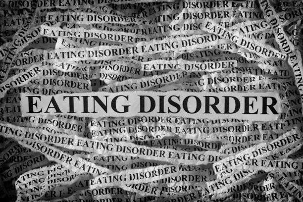 Torn pieces of paper with the words Eating Disorder. Eating Disorder. Torn pieces of paper with the words Eating Disorder. Concept Image. Black and White. Closeup. eating disorder stock pictures, royalty-free photos & images