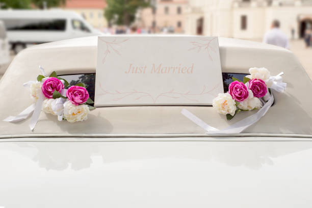 istock White wedding limousine decorated with flowers 815718110
